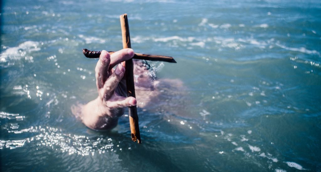 Drowning man with cross