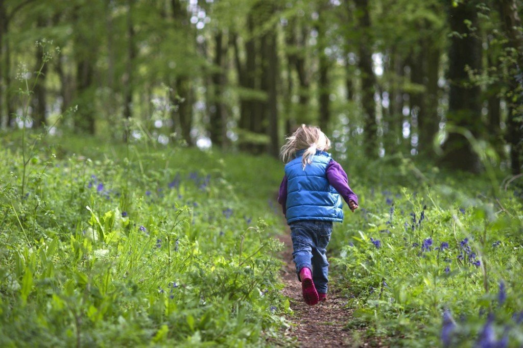 Girl Running Through Flowers