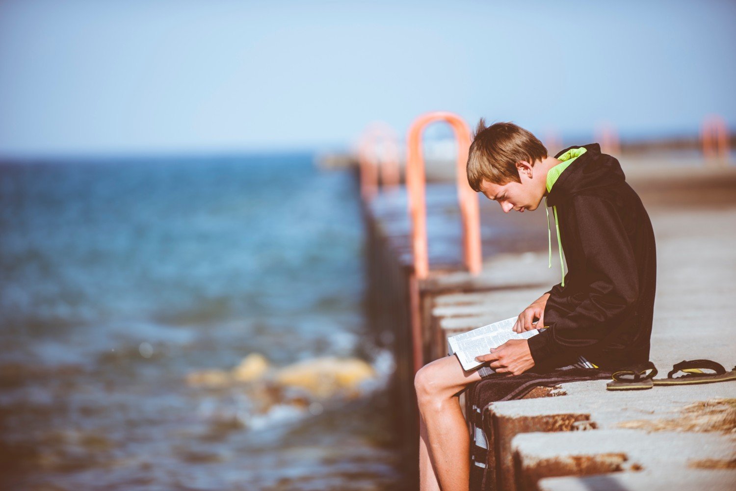 boy-reading-on-pier.jpg