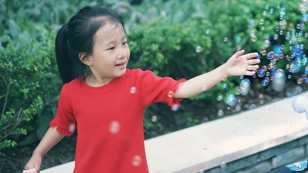 girl-playing-with-bubbles