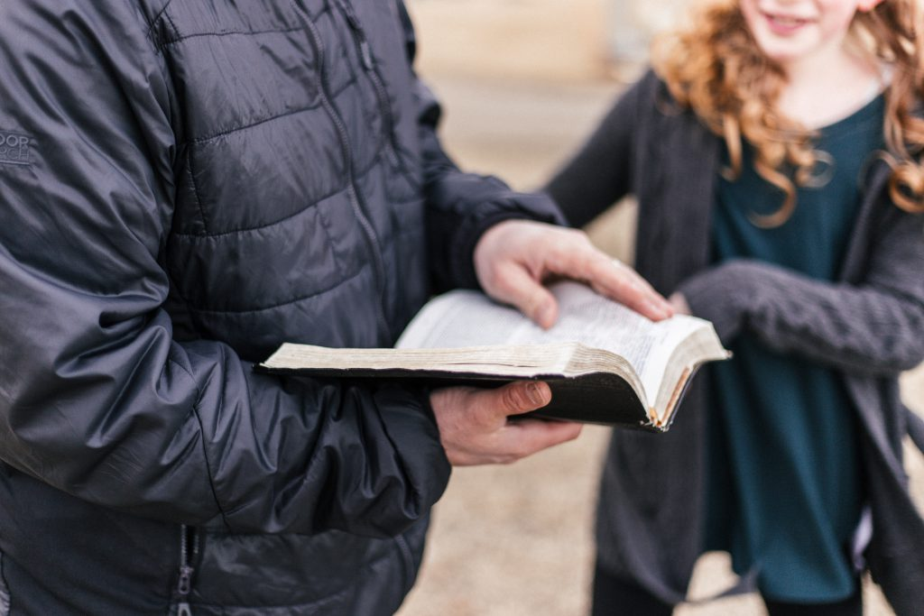 Man holding an inexpensive Bible