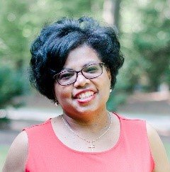 A person wearing glasses and a red shirt Description automatically generated