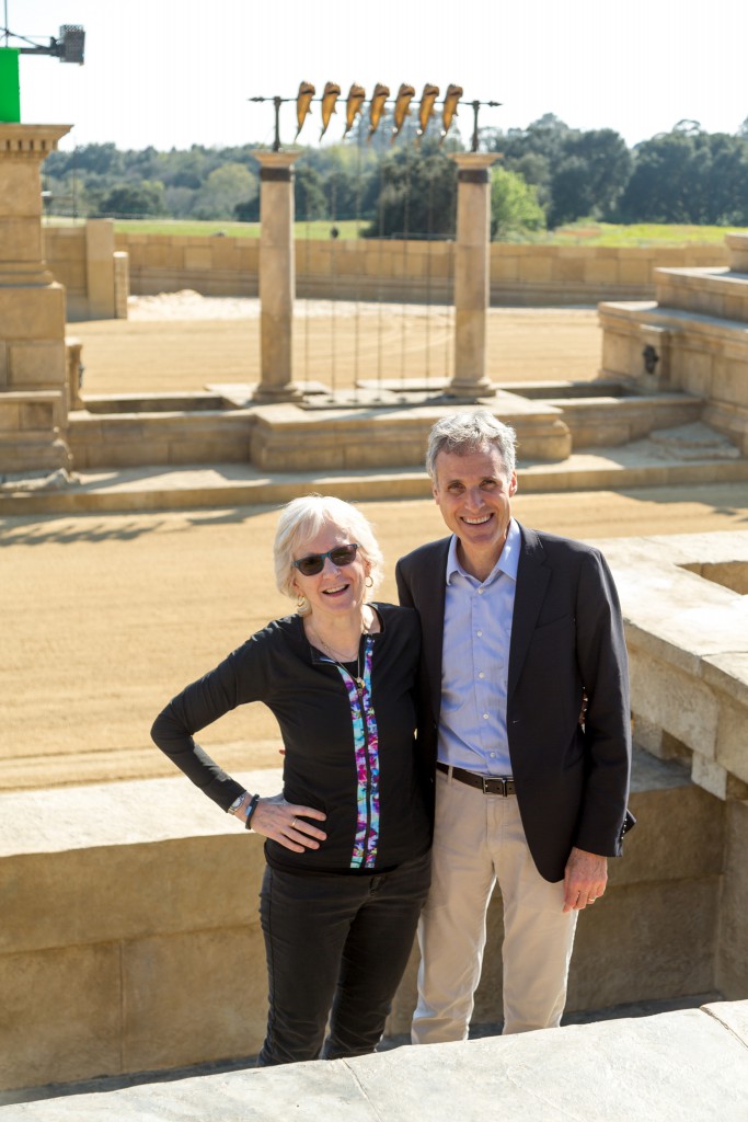 Carol stands in front of coliseum set.
