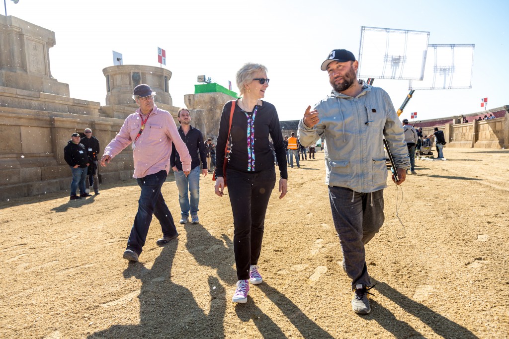 Carol walks with the director through the set.
