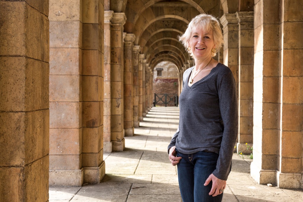 Carol Wallace poses in a passage way on the Ben-Hur set.